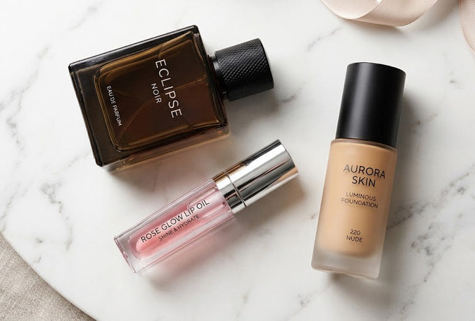 Dior Sauvage perfume, Dior Lip Oil, and Backstage Foundation displayed on a marble surface representing luxury beauty in Qatar.
